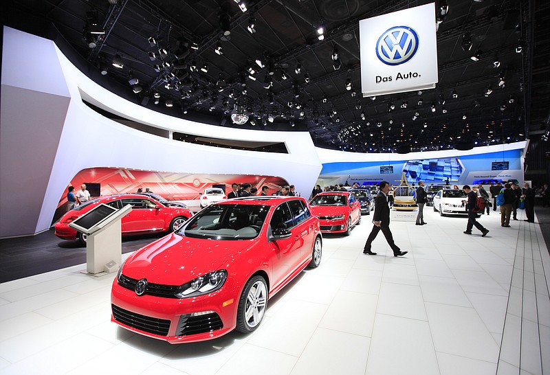 Press browse the VW booth before Volkswagen unveiled a new hybrid Jetta and electric concept vehicle, the "Bugstger," at the COBO Center during the 2012 North American International Auto Show in Detroit, Michigan, in this file photo.