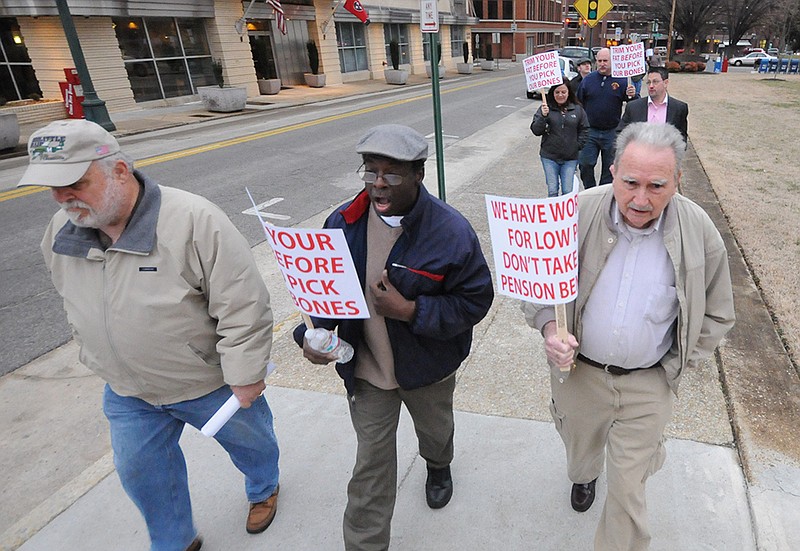 Chattanooga fire captain Ron Delker, from left, retired policeman Ezra Harris and retired fireman Bill York walk with 30 others to City Hall for a City Council meeting Tuesday in protest of Chattanooga Mayor Andy Berke's recent pension reform.