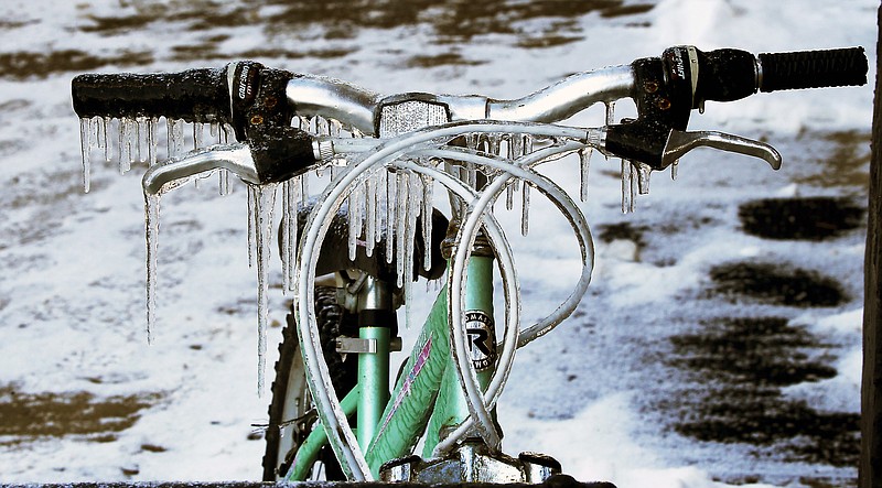 Icicles hang from the handlebars of a bicycle outside a coffee shop in Harmony, Pa.