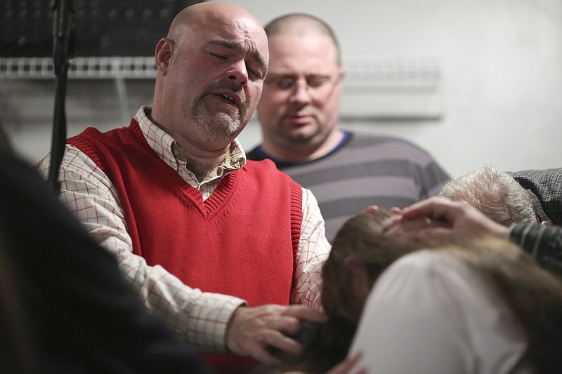 Pastor Jamie Coots lays hands in prayer during a service at the Full Gospel Tabernacle In Jesus Name church located in Middlesboro, Ky.