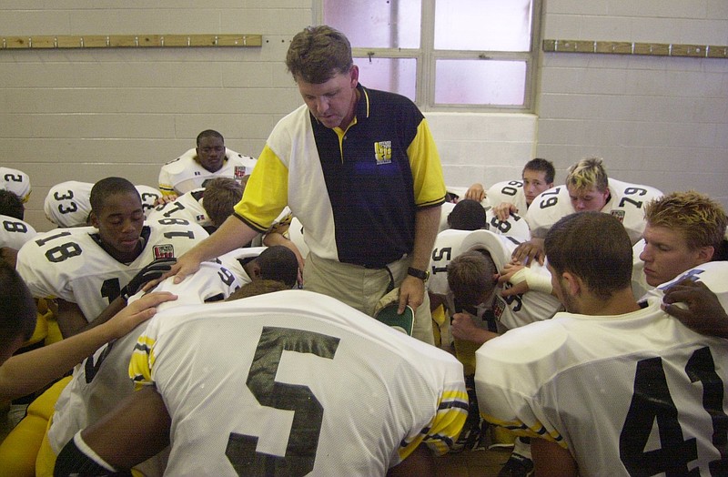 Dan Duff leads the Hixson High School football team in prayer in this 2000 file photo.