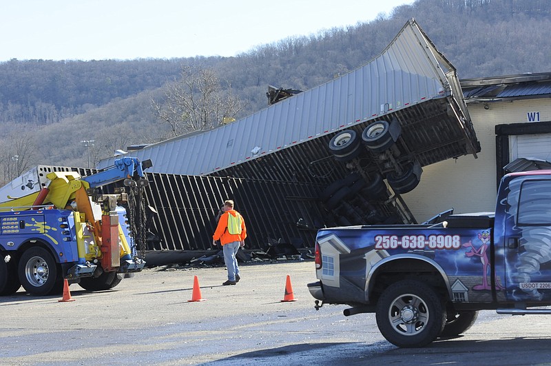 A Yates wrecker serviceman assesses two 53-foot trailers toppled by high
winds early Friday morning at Jet Polymer Recycling in Fort Payne, Ala.