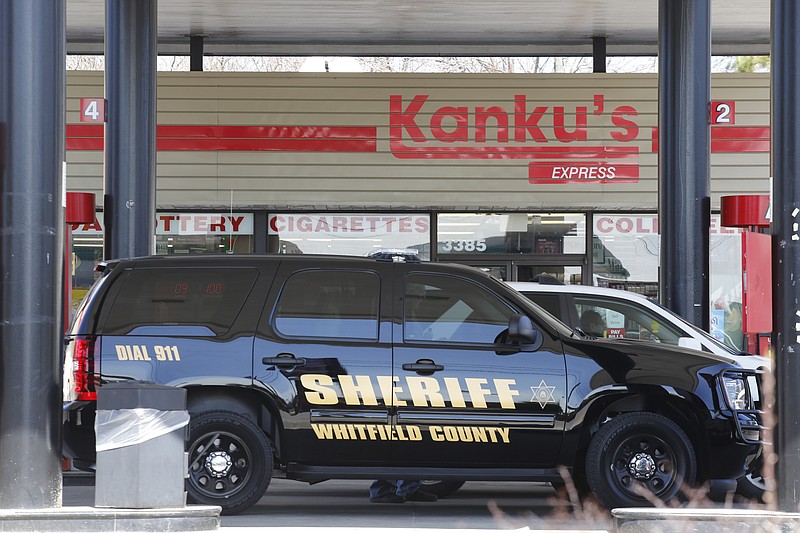 A Whitfield County sheriff's vehicle is parked in front of a Kanku's Express on Monday after a kiling at the gas station in Dalton, Ga.