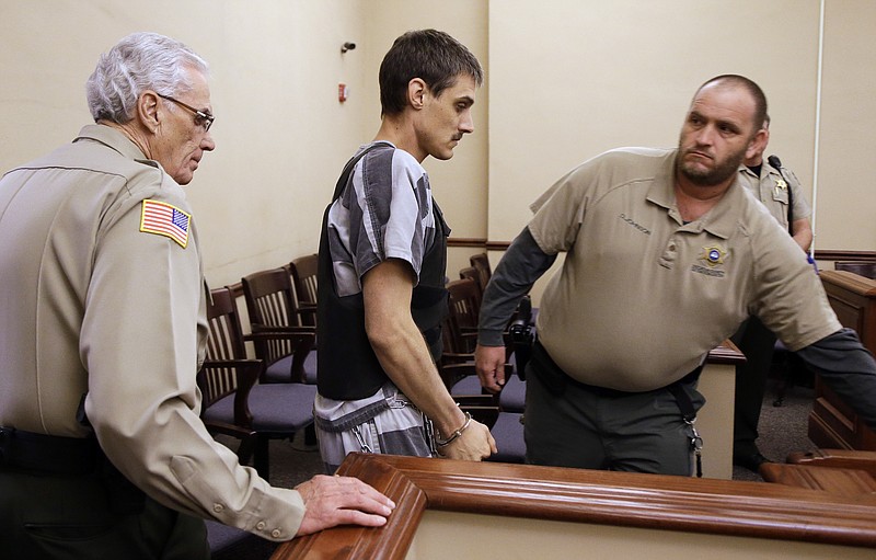 Zachary Adams, center, is led into a courtroom in the Decatur Country Courthouse on Tuesday in Decaturville, Tenn. Adams, accused of abducting and killing nursing student Holly Bobo, was arraigned on charges of kidnapping and murder. He pleaded innocent. Bobo disappeared April 13, 2011, outside her home near Parsons, Tenn.