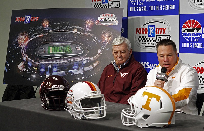 Tennessee head football coach Butch Jones, right,  speaks during a press conference along with Virginia Tech head football coach Frank Beamer to promote "The Battle of Bristol" NCAA football game between their schools in 2016, prior to the NASCAR Sprint Cup series auto race at Bristol Motor Speedway on Sunday in Bristol, Tenn.