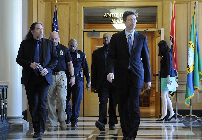 David Kennedy, left,  is followed by Chattanooga police Lt. Todd Royval, Capt. Edwin McPherson and Paul Smith as they walk with Mayor Andy Berke, foreground, to a news conference inside City Hall in this file photo.