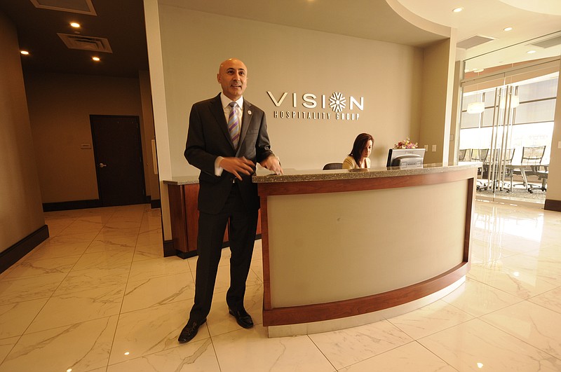 Mitch Patel, president and CEO of Vision Hospitality Group, stands in the almost finished
reception area in his new 13,000 square-foot office.