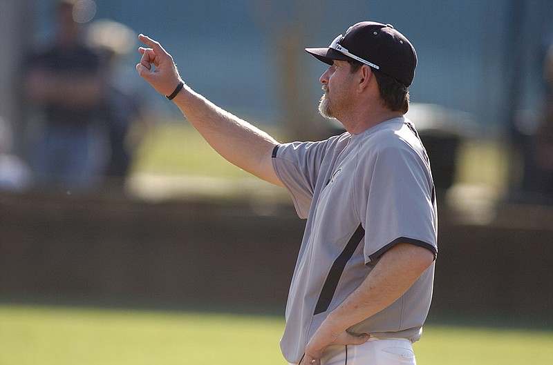 Calhoun head baseball coach Chip Henderson signals a baserunner during the Jackets's game with Gordon Lee in Chickamauga.