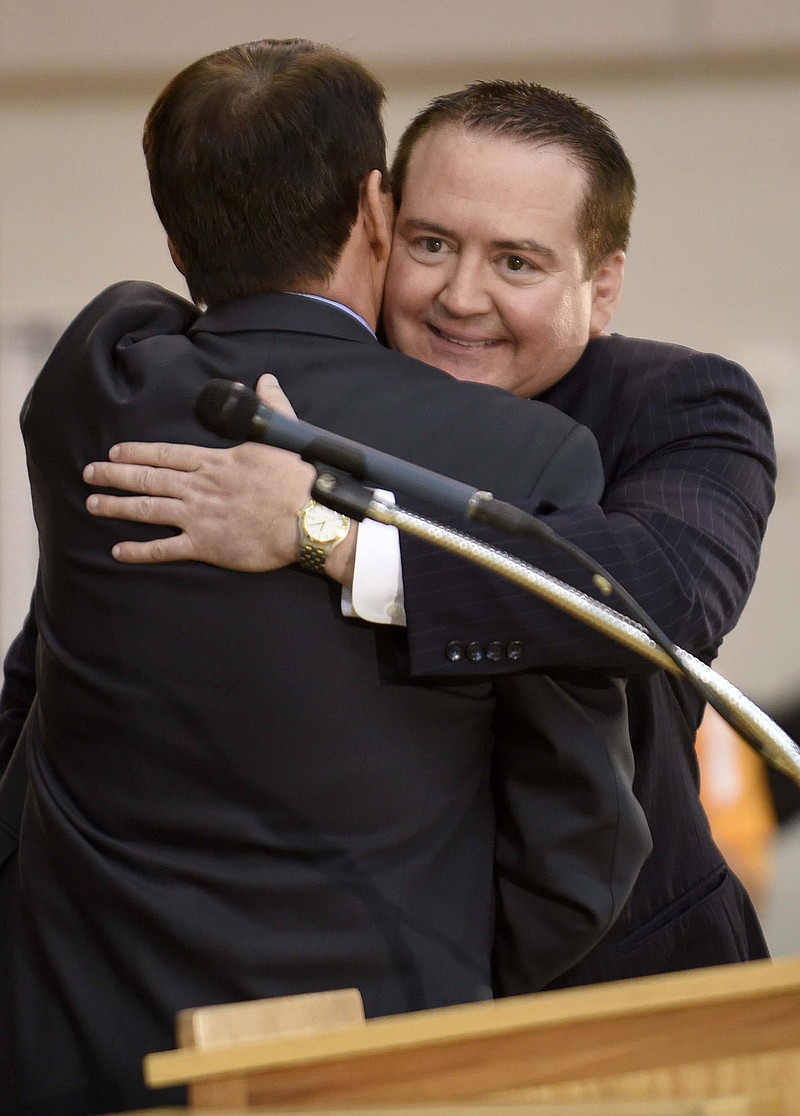 Tennessee men's basketball coach Donnie Tyndall, right, is hugged by athletic director Dave Hart during a news conference Tuesday in Knoxville. The former Southern Mississippi coach succeeds Cuonzo Martin, who resigned last week to take the head job at California.