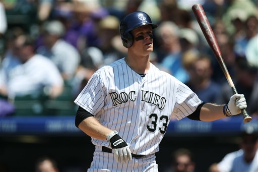 Colorado Rockies first baseman Justin Morneau (33) swings at the