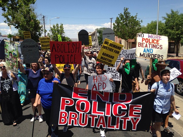 
              In this photo courtesy of David Correia, protesters march in a rally on Saturday, June 21, 2014 in Albuquerque, N.M. Critics of the Albuquerque Police Department say the march is aimed at pushing for drastic changes within Albuquerque police following a harsh U.S. Justice Department report over the agency’s use of force. (AP Photo/Courtesy of David Correia)
            