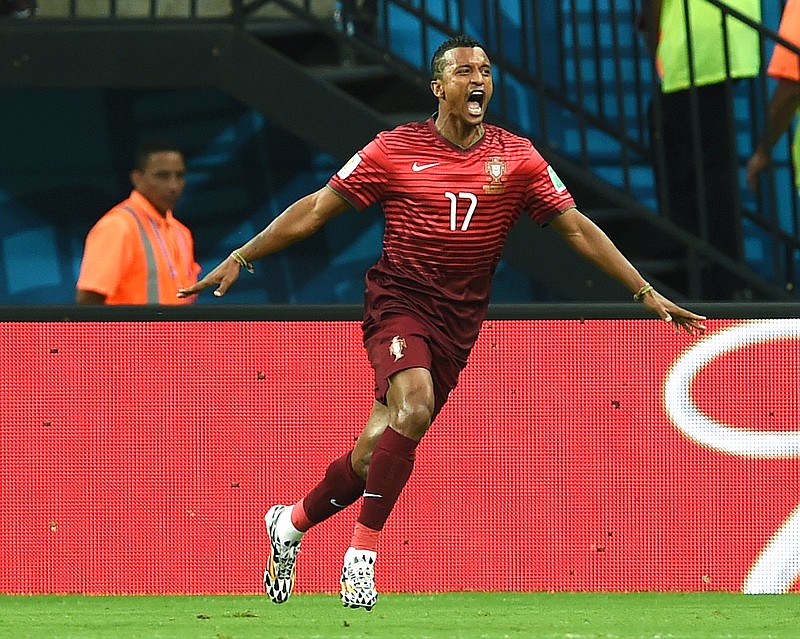 
              Portugal's Nani celebrates after scoring the opening goal during the group G World Cup soccer match between the USA and Portugal at the Arena da Amazonia in Manaus, Brazil, Sunday, June 22, 2014.  (AP Photo/Paulo Duarte)
            