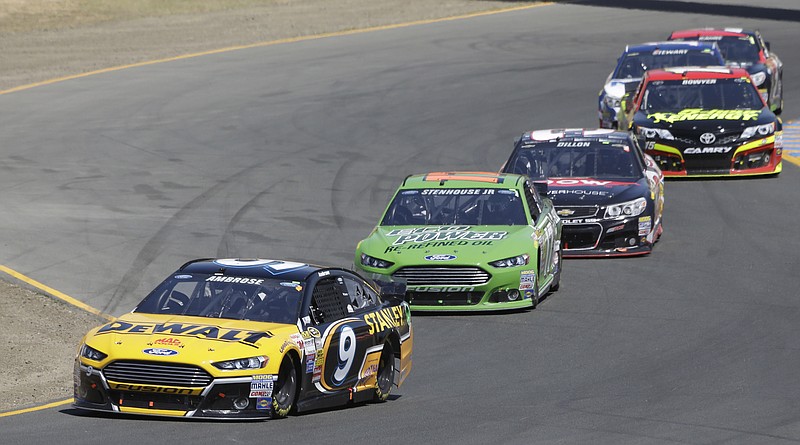 
              Marcos Ambrose (9), of Australia, leads Ricky Stenhouse Jr., Austin Dillon, Clint Bowyer, Tony Stewart and Kasey Kahne during the NASCAR Sprint Cup Series auto race Sunday, June 22, 2014, in Sonoma, Calif. (AP Photo/Eric Risberg)
            