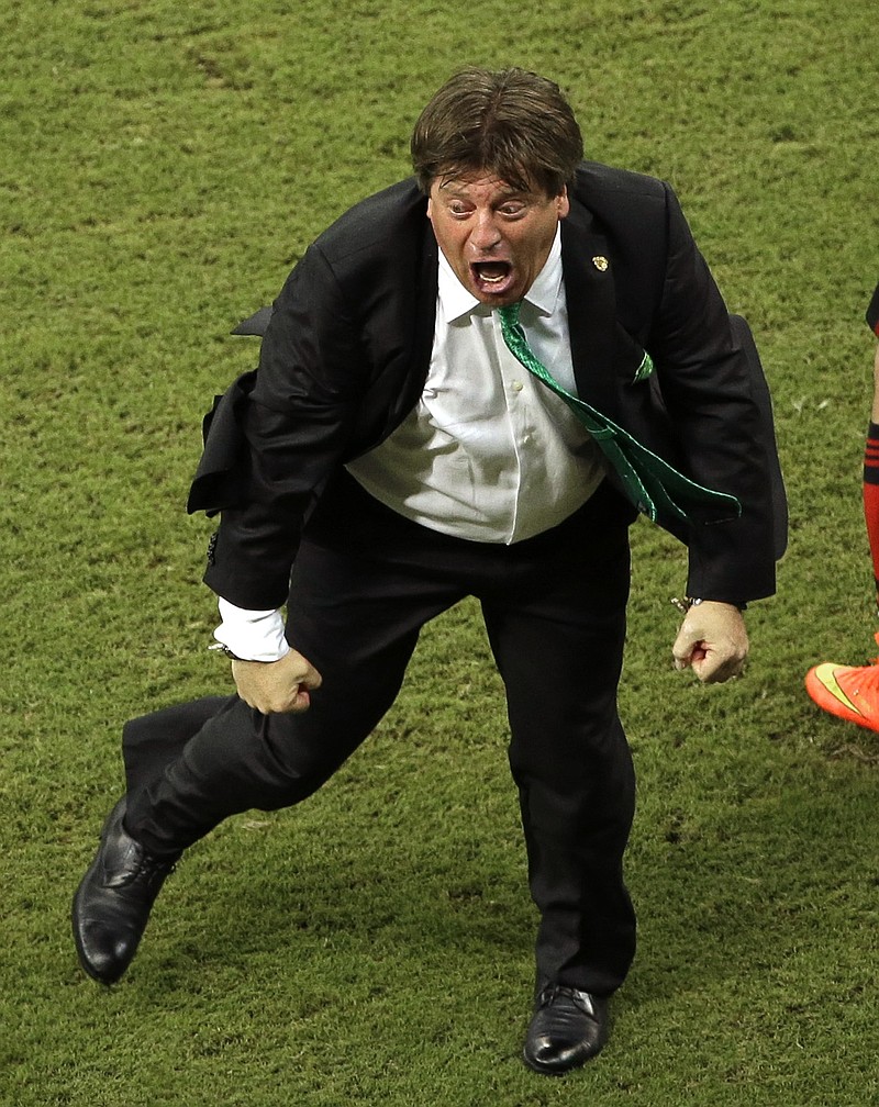 
              In this June 23, 2014 photo, Mexico's head coach Miguel Herrera celebrates after Mexico's Andres Guardado scored Mecico's side's second goal during the group A World Cup soccer match between Croatia and Mexico at the Arena Pernambuco in Recife, Brazil. Mexico’s national soccer coach just can’t keep his joy bottled up, and his enthusiasm has made him one of the most entertaining and popular figures of the World Cup and an Internet sensation worldwide.  (AP Photo/Hassan Ammar)
            