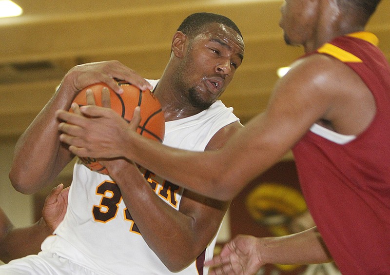 Tyner's Trey Suttles (34) fights for possession of the ball with Howard's Anthony Smith (10) at Tyner Academy in 2012.