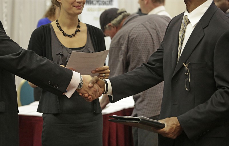 
              In this May 29, 2013 photo, job seeker Craig Cline of Lincolnwood, Ill., right, meets with Jeremy Skeeters, left, and Lindy Hammel, of Aflac Insurance Co., during a career fair in Rolling Meadows, Ill. Five years after the Great Recession officially ended, most states still haven’t regained all the jobs they lost _ even though the nation as a whole has. In May 2014, the overall economy finally recovered all 9 million jobs that vanished in the worst downturn since the 1930s. Another month of solid hiring is expected in the U.S. jobs report for June that will be released Thursday, July 3. (AP Photo/M. Spencer Green)
            