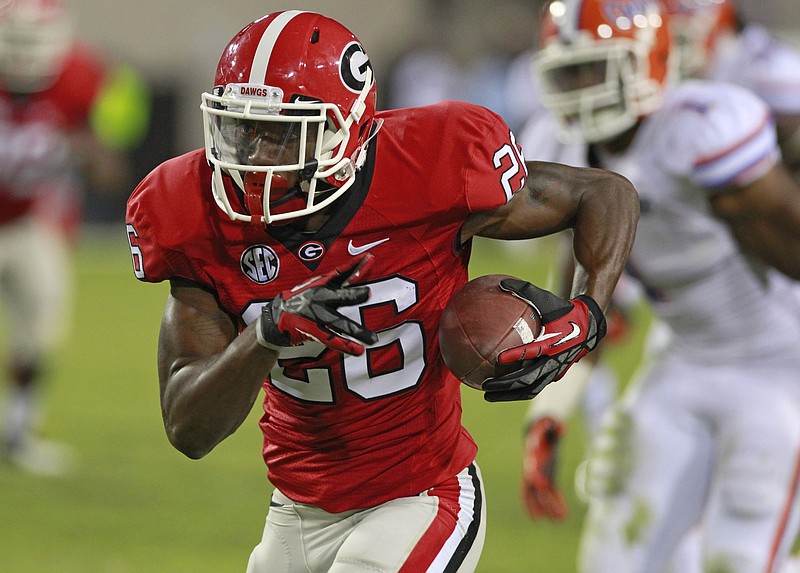 Georgia's Malcolm Mitchell (26) runs past the Florida defense after a pass reception for a 45-yard touchdown.