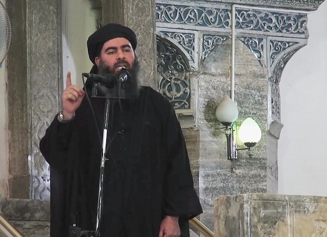 
              This image made from video posted on a militant website Saturday, July 5, 2014, which has been authenticated based on its contents and other AP reporting, purports to show the leader of the Islamic State group, Abu Bakr al-Baghdadi, delivering a sermon at a mosque in Iraq. A video posted online Saturday purports to show the leader of the Islamic State extremist group that has overrun much of Syria and Iraq delivering a sermon at a mosque in Iraq, in what would be a rare - if not the first - public appearance by the shadowy militant. (AP Photo/Militant video)
            