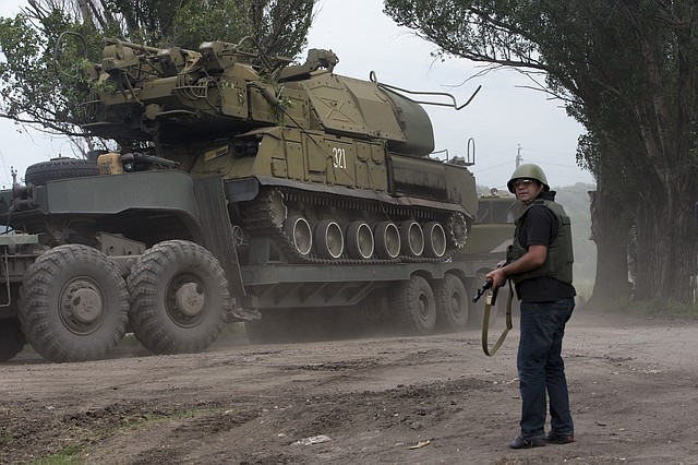 
              Ukrainian government forces maneuver antiaircraft missile launchers Buk as they are transported north-west from Slavyansk, eastern Ukraine Friday, July 4, 2014. (AP Photo/Dmitry Lovetsky)
            