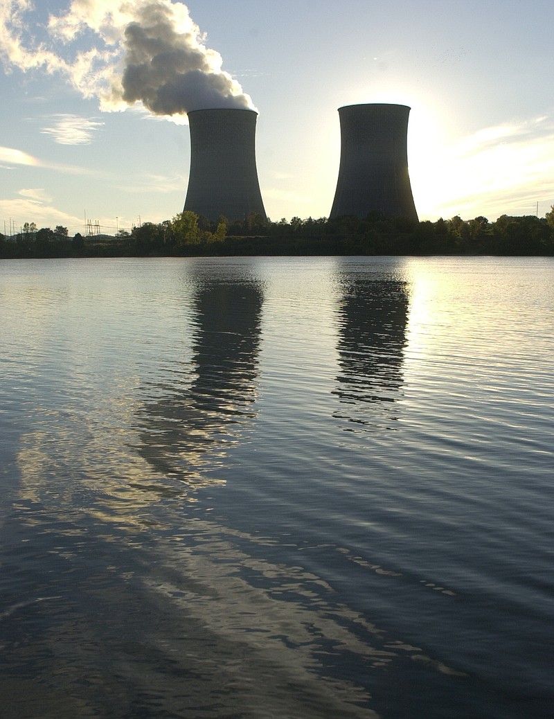 The nuclear power plant towers at Watts Bar are reflected in Watt's Bar lake during a clear late evening sun set.