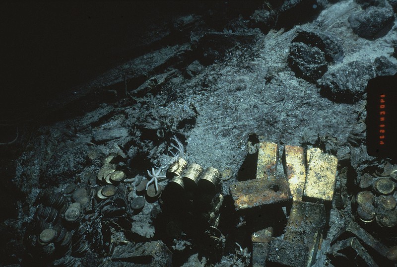 
              FILE - This 1989 file photo shows gold bars and coins from the S.S. Central America, a mail steamship, which sunk in a hurricane in 1857, about 160 miles off the North Carolina coast. Federal Judge Rebecca Beach Smith ruled Wednesday, July 9, 2014, that an Ohio company named Recovery Limited Partnership has salvage rights to the SS Central America. (AP Photo/File)
            