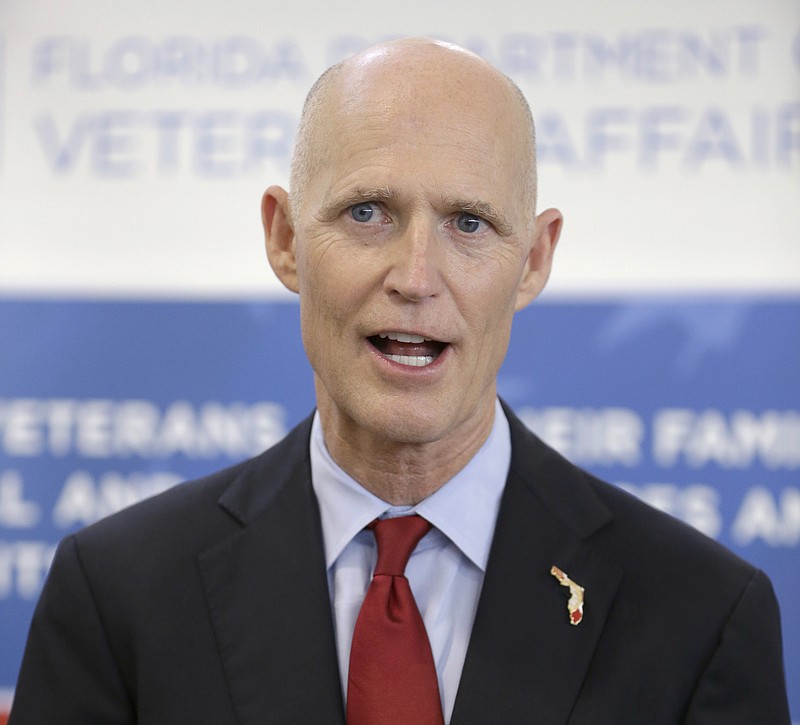 
              FILE- In this April 29, 2014 file photo, Florida Gov. Rick Scott speaks to members of the media after a ceremony during which he presented  "Governor's Veterans Service Award," medals to veterans in Fort Lauderdale, Fla. Gov. Scott’s campaign for re-election is hitting Democratic rival Charlie Crist with a barrage of attacks but his campaign team has also committed a series of blunders this year. (AP Photo, File)
            