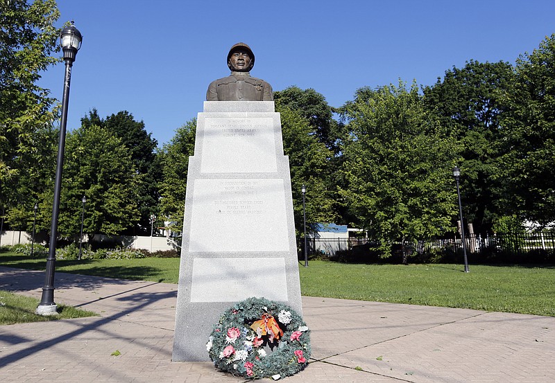 
              A statue of Henry Johnson is displayed in the Arbor Hill neighborhood on Thursday, July 10, 2014, in Albany, N.Y. U.S. Defense Secretary Chuck Hagel will consider whether the black World War I hero from Albany should be posthumously awarded the Medal of Honor nearly 100 years after he single-handedly fought off a German attack, killing several of the enemy and saving a comrade despite suffering serious wounds. Johnson was a solider in an all-black outfit, the 369th Infantry Regiment, a New York National Guard unit based in Manhattan and known as the Harlem Hellfighters. (AP Photo/Mike Groll)
            