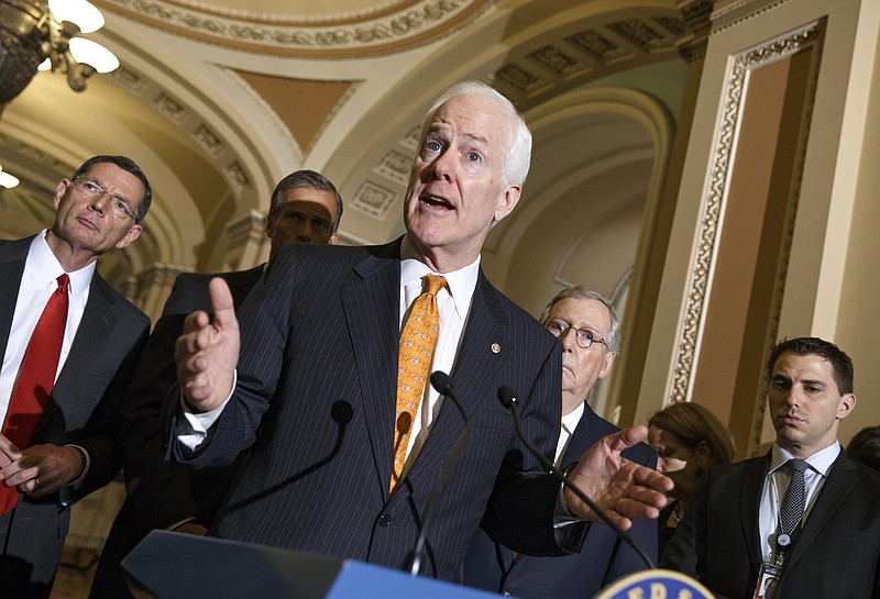 
              Senate Minority Whip John Cornyn of Texas, center, defends legislation he has authored with fellow Texan Rep. Henry Cuellar, D-Texas, to speed removals of tens of thousands of Central American kids flowing over the U.S.-Mexico border as Washington searched for a solution to the growing crisis, Tuesday, July 15, 2014, during a news conference onn Capitol Hill in Washington. From left are, Sen. John Barrasso, R-Wyo., Sen. John Thune, R-S.D., Cornyn and Senate Minority Leader Mitch McConnell of Ky. (AP Photo/J. Scott Applewhite)
            