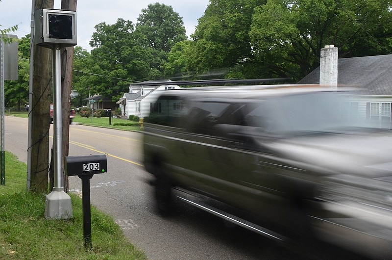 Cars zip past a new speed camera on the 200th block of Germantown Road. The camera has been making significant money on fines since its installation.