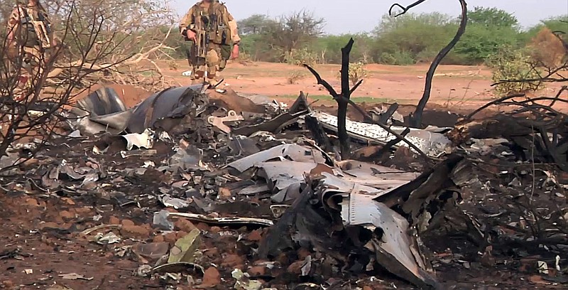 
              This photo provided Friday July 25, 2014 by the French army shows soldiers at the site of the plane crash in Mali. French soldiers secured a black box from the Air Algerie wreckage site in a desolate region of restive northern Mali on Friday, the French president said. Terrorism hasn't been ruled out as a cause, although officials say the most likely reason for the catastrophe that killed all onboard is bad weather. At least 116 people were killed in Thursday's disaster, nearly half of whom were French. (AP Photo/ECPAD)
            