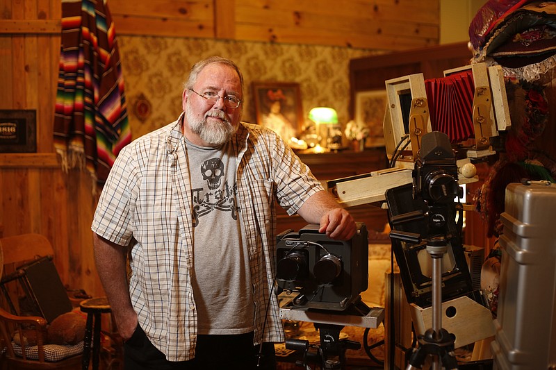 Small business owner Mark Horner poses for a photo in his Old Tyme Photos studio.