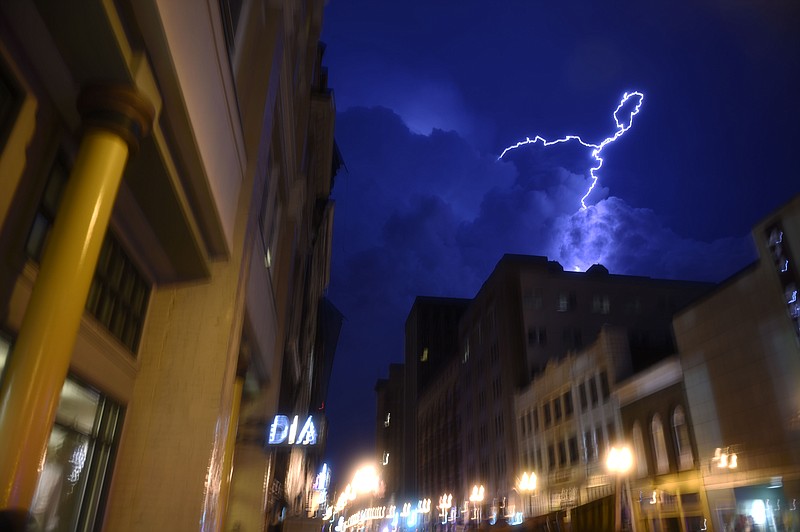 
              Lightning strikes over downtown in Knoxville, Tenn., on Sunday, July 27, 2014. Authorities say powerful storms crossing east Tennessee have destroyed 10 homes and damaged others, though there are no immediate reports of any deaths or injuries. (AP Photo/The Knoxville News Sentinel, Saul Young)
            