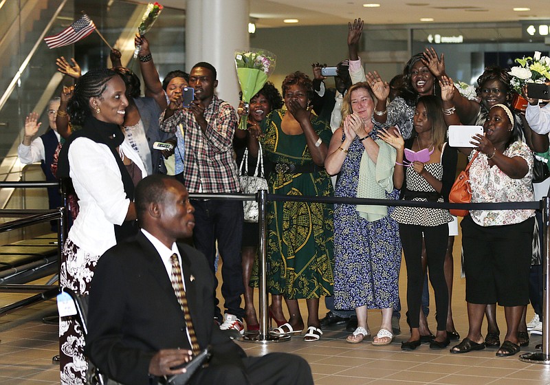 
              Meriam Ibrahim, left, and her husband, Daniel Wani, of Sudan, are greeted by family and friends shortly after arriving in Manchester, N.H., Thursday, July 31, 2014. Ibrahim, who refused to recant her Christian faith in the face of a death sentence that was later overturned, will make their new home in New Hampshire. (AP Photo/Charles Krupa)
            