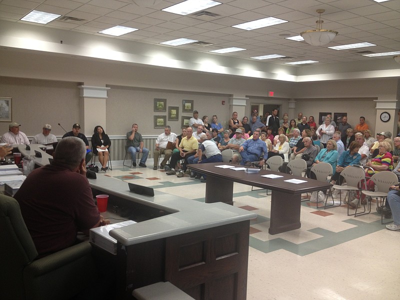 County Commissioner Mitchell Smith looks at a group of Dade County residents, most of whom objected to a 2014 proposal of a 44 percent property tax increase. Smith and the rest of the commission refused to vote for the proposal.