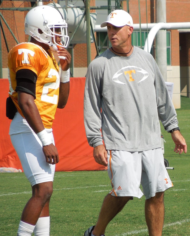 Tennessee secondary coach Willie Martinez talks to freshman cornerback Evan Berry during the Vols' practice on Sunday.