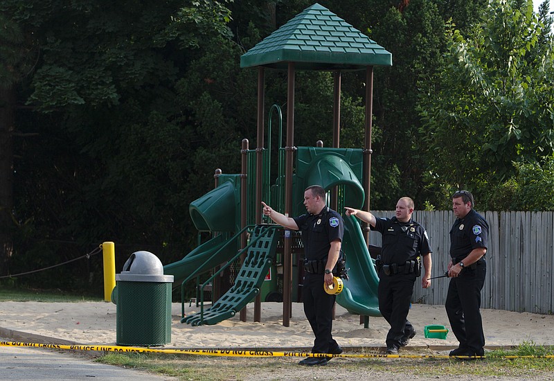 
              Kentwood police investigate a stabbing that occurred in a playground in Pinebrook Village, in Kentwood, Mich., on  Aug. 4, 2014.   Police say a 12-year-old boy has stabbed a 9-year-old boy at the playground in western Michigan, sending the child to a hospital.   Police also didn't immediately release detail on the condition of the wounded child. The older boy was taken into custody for questioning by police. (AP Photo/The Grand Rapids Press, Joel Bissell) ALL LOCAL TELEVISION OUT; LOCAL TELEVISION INTERNET OUT
            