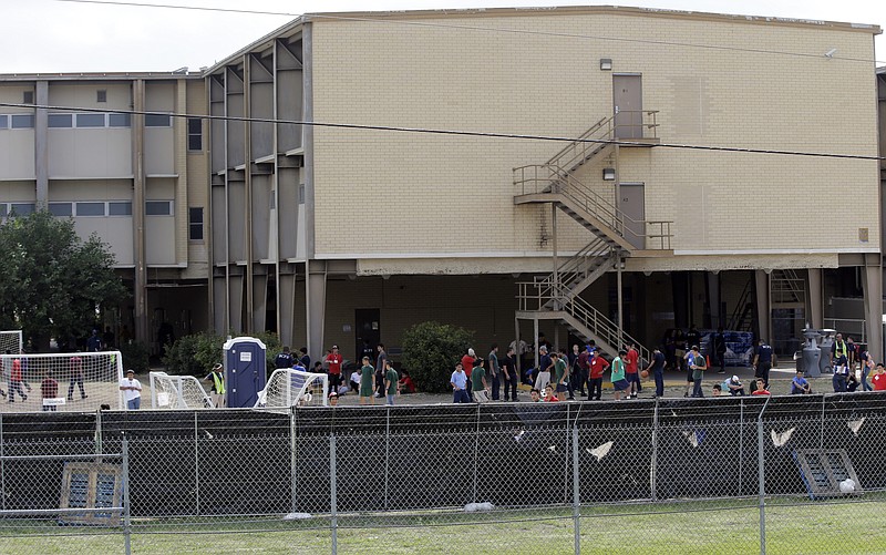 
              FILE - This June 23, 2014 file photo shows a temporary shelter for unaccompanied minors who have entered the country illegally at Lackland Air Force Base in San Antonio. The government said Monday it will soon close three emergency shelters it established at U.S. military bases to temporarily house children caught crossing the Mexican border alone. It said fewer children were being caught and other shelters will be adequate.  (AP Photo/Eric Gay, File)
            