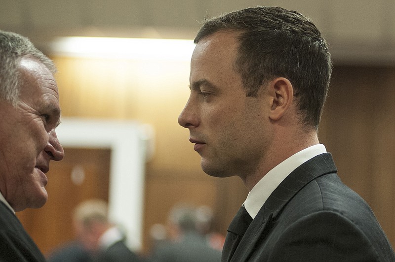 
              FILE: In this Monday June 30, 2014 file photo Oscar Pistorius listens to his lawyer Barry Roux, left, in court in Pretoria, South Africa.Prosecutors and lawyers for Oscar Pistorius have one last chance to convince a South African judge when they present closing arguments this week in the murder trial of the once-celebrated athlete who fatally shot his girlfriend, Reeva Steenkamp, through a toilet cubicle door in his home. On Thursday Aug. 7, 2014 and Friday, both sides will summarize their versions of the shooting to Thokozile Masipa, the red-robed judge who will determine the fate of the double-amputee Olympic runner. bedroom.  (AP Photo/Ihsaan Haffejee, Pool, File)
            