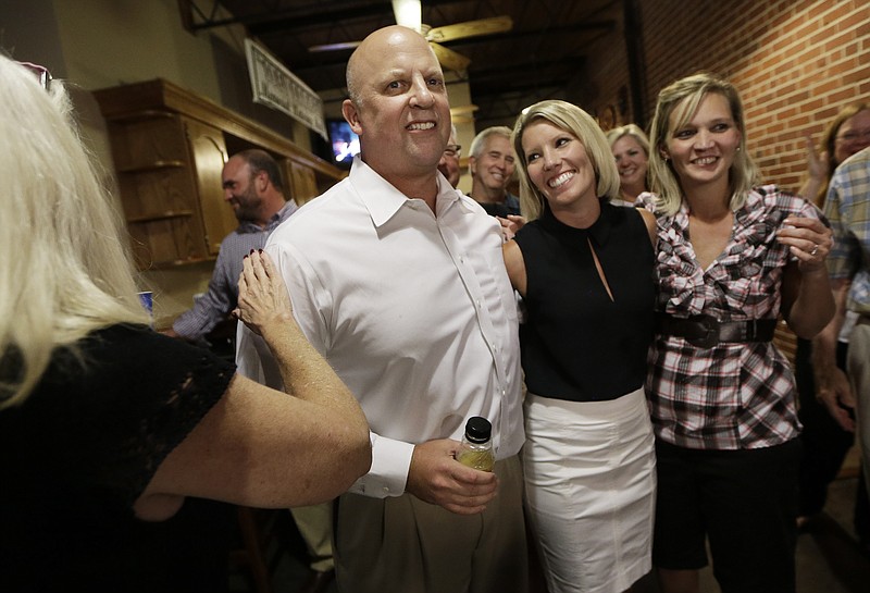 U.S. Rep. Scott DesJarlais, R-Tenn., and his wife, Amy, second from right, are
cheered Thursday in South Pittsburg, Tenn.
