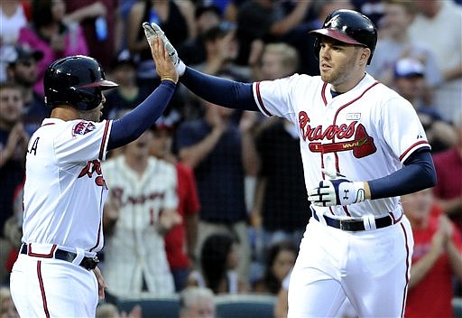 Atlanta Braves' Freddie Freeman, right, is congratulated at home plate by Tommy La Stella after Freeman's two-run homer against the Washington Nationals during their game Friday, Aug. 8, 2014, in Atlanta.