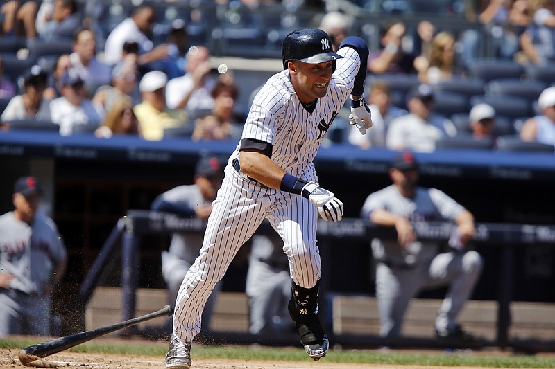 New York Yankees Derek Jeter throws to first base against the