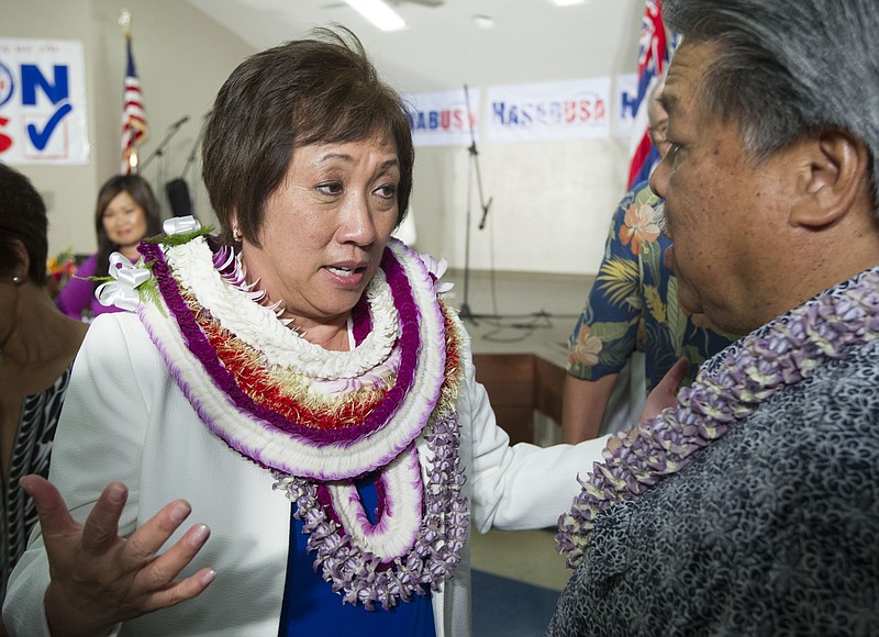 
              U.S. Rep. Colleen Hanabusa, Democrat, from Hawaii's 1st district, talks to former Hawaii Governor Ben Cayetano, right, at her campaign headquarters Saturday, Aug. 9, 2014, in Honolulu. Hanabusa is locked in a tight race with incumbent Sen. Brian Schatz in the state's Primary Election. (AP Photo/Eugene Tanner)
            