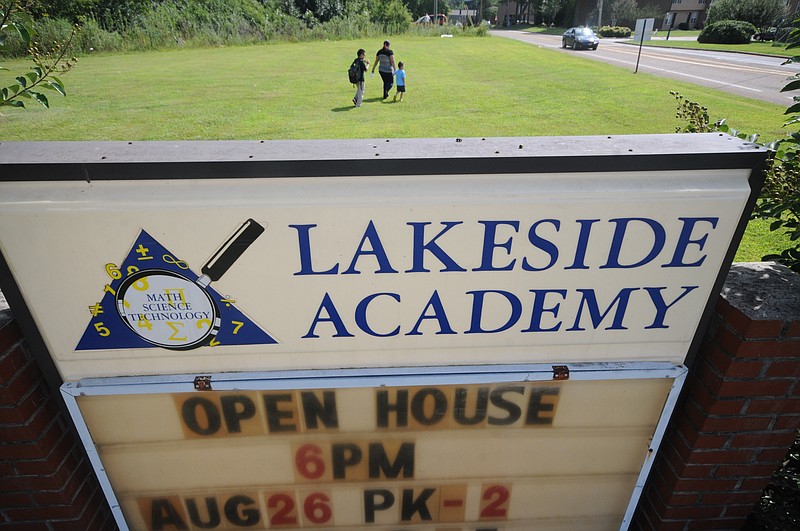 A mother and two children walk away from Lakeside Academy on Thursday in the 4800 block of Jersey Pike. There are no visible crosswalks for children adjoining the school property.