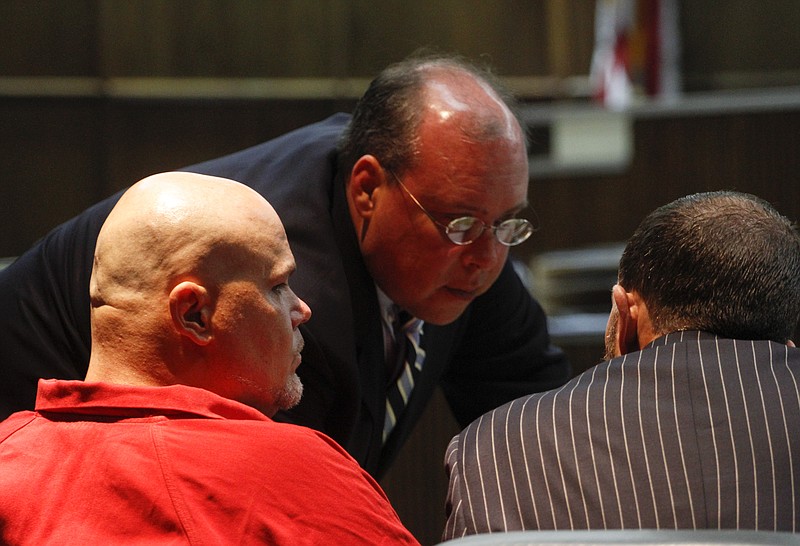 Defense attorneys Paul Bruno, center, and Luke Evans, right, converse in this file photo while appearing before Judge Don Poole during the case of Marlon Duane Kiser, left.