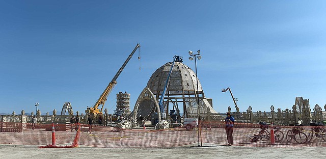 
              Artists and volunteers work on the Temple of Grace at the annual Burning Man event on the Black Rock Desert of Gerlach, Nev, on Aug. 24, 2014, a day before the event opens to ticket holders. (AP Photo/Reno Gazette-Journal, Andy Barron) NO SALES; NEVADA APPEAL OUT; SOUTH RENO WEEKLY OUT
            