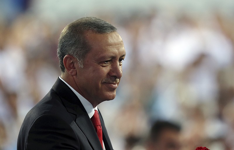 
              President-elect Recep Tayyip Erdogan addresses his supporters in Ankara, Turkey, Wednesday, Aug. 27, 2014. Turkey's ruling party is holding a congress to confirm Turkey's Foreign Minister Ahmet Davutoglu as its new chairman and prime minister-designate, to replace Erdogan. Erdogan, who is scheduled to be sworn in as president on Thursday, hand-picked his stalwart ally Davutoglu to succeed him. (AP Photo/Burhan Ozbilici)
            