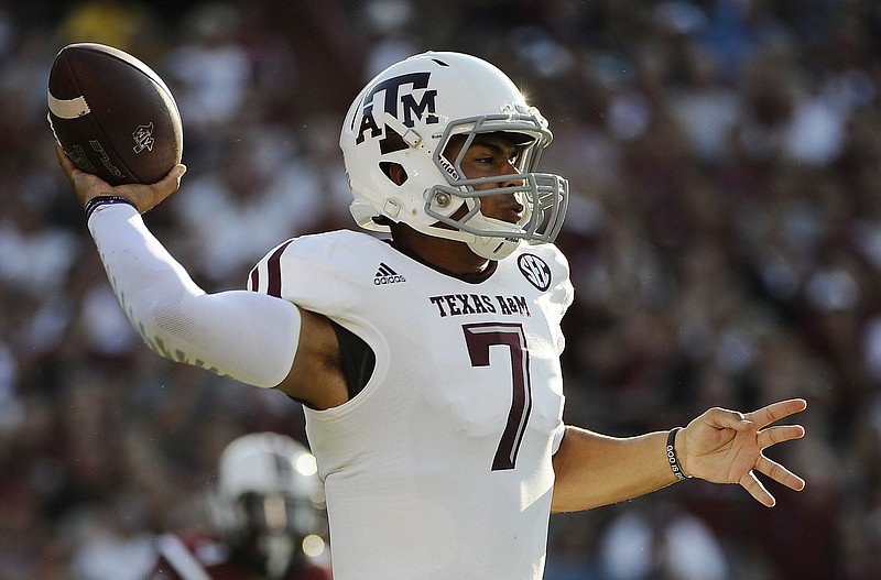 
              Texas A&M quarterback Kenny Hill (7) throws against South Carolina during the first half of an NCAA college football game on Thursday, Aug. 28, 2014, in Columbia, S.C. (AP Photo/Rainier Ehrhardt)
            