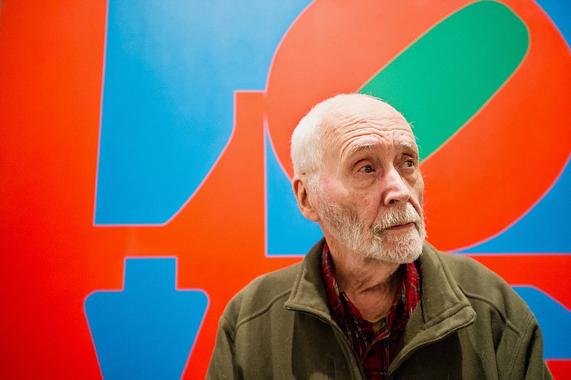 
              FILE - In this Sept. 24, 2013, file photo, artist Robert Indiana, known world over for his LOVE image, is interviewed in front of that painting at New York's Whitney Museum of American Art. The Maine-based pop artist plans to participate in International HOPE Day, a celebration of his art in countries across the world. Indiana will make a public appearance at noon outside his residence and studio on Vinalhaven Island on Sept. 13.(AP Photo/Lauren Casselberry, File)
            