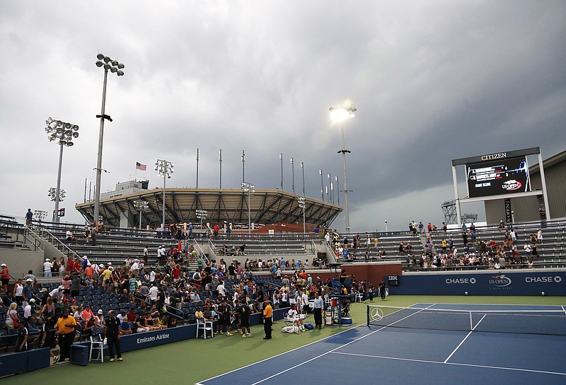 
              Play is suspended as storm clouds roll over the Billie Jean King National Tennis Center because of imminent lighting during the 2014 U.S. Open tennis tournament, Sunday, Aug. 31, 2014, in New York. (AP Photo/Elise Amendola)
            