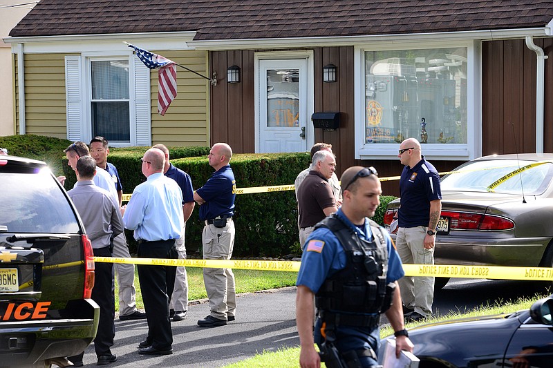 
              Police mill about outside a home in Hasbrouck Heights, N.J., Wednesday, Sept. 3, 2014, where they say an elderly man fatally shot his wife and brother-in-law before turning the gun on himself. (AP Photo/The Record of Bergen County, Tariq Zehawi) ONLINE OUT; MAGS OUT; TV OUT; INTERNET OUT;  NO ARCHIVING; MANDATORY CREDIT
            